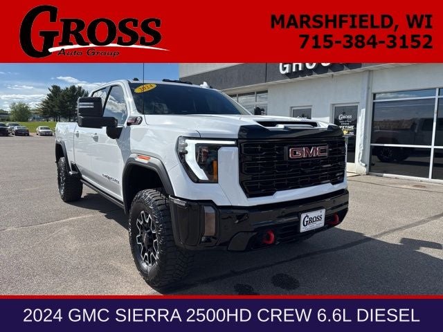 2024 GMC Sierra 2500HD AT4X in Summit White — front three-quarter view